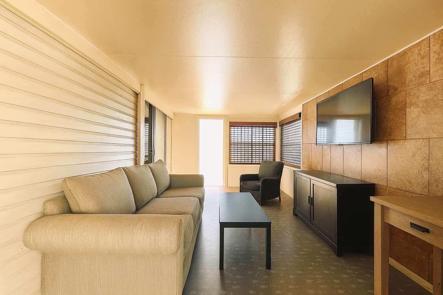 1601 Highway 441, Unit 61 Okeechobee, FL 34974 - Photo 11 of 35 a living room with furniture and a flat screen tv