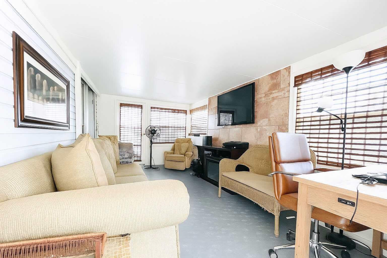 1601 Highway 441, Unit 61 Okeechobee, FL 34974 - Photo 14 of 35 a living room with furniture and a flat screen tv