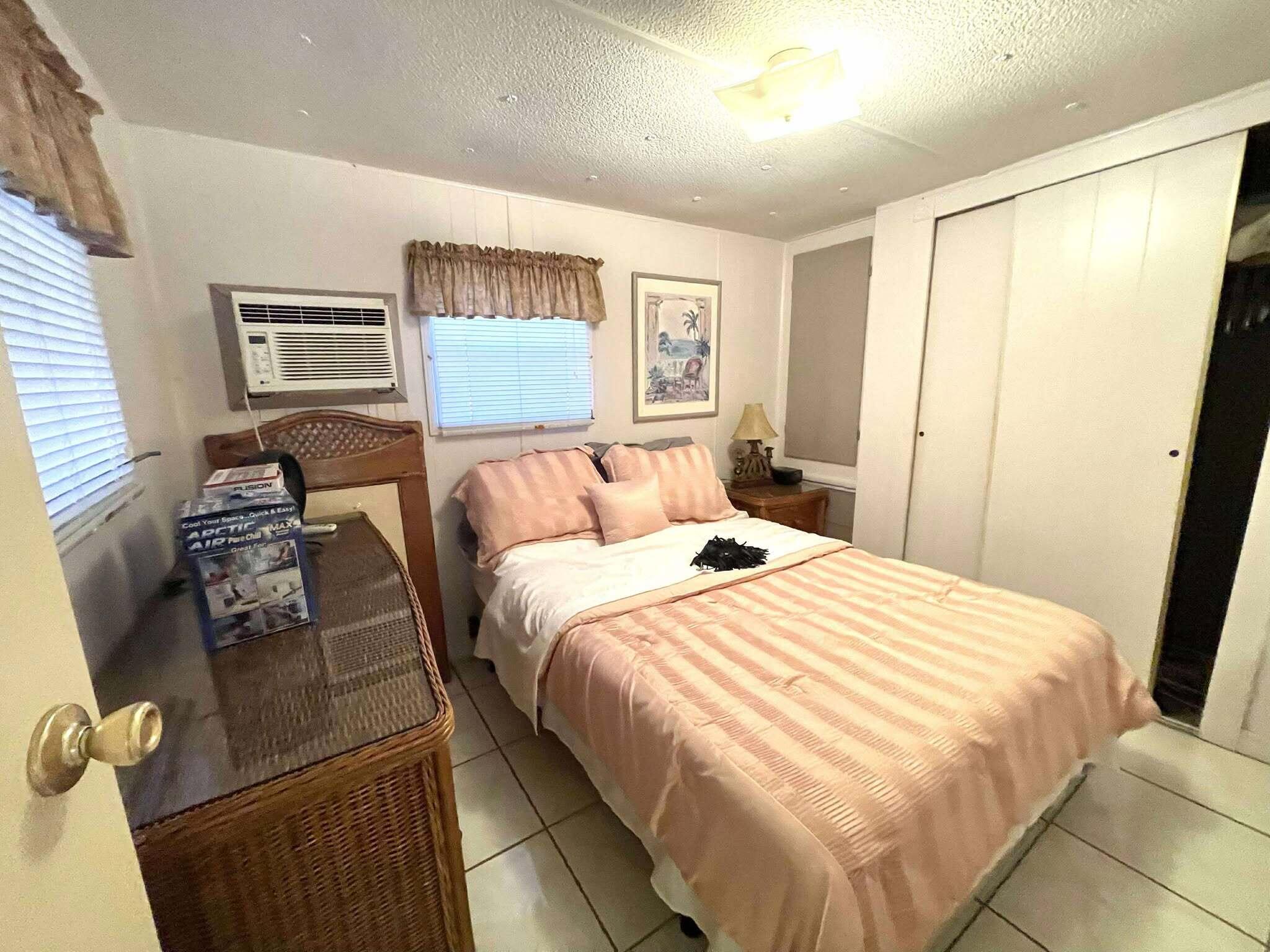 1601 Highway 441, Unit 61 Okeechobee, FL 34974 - Photo 15 of 35 a bedroom with a bed and wooden floor