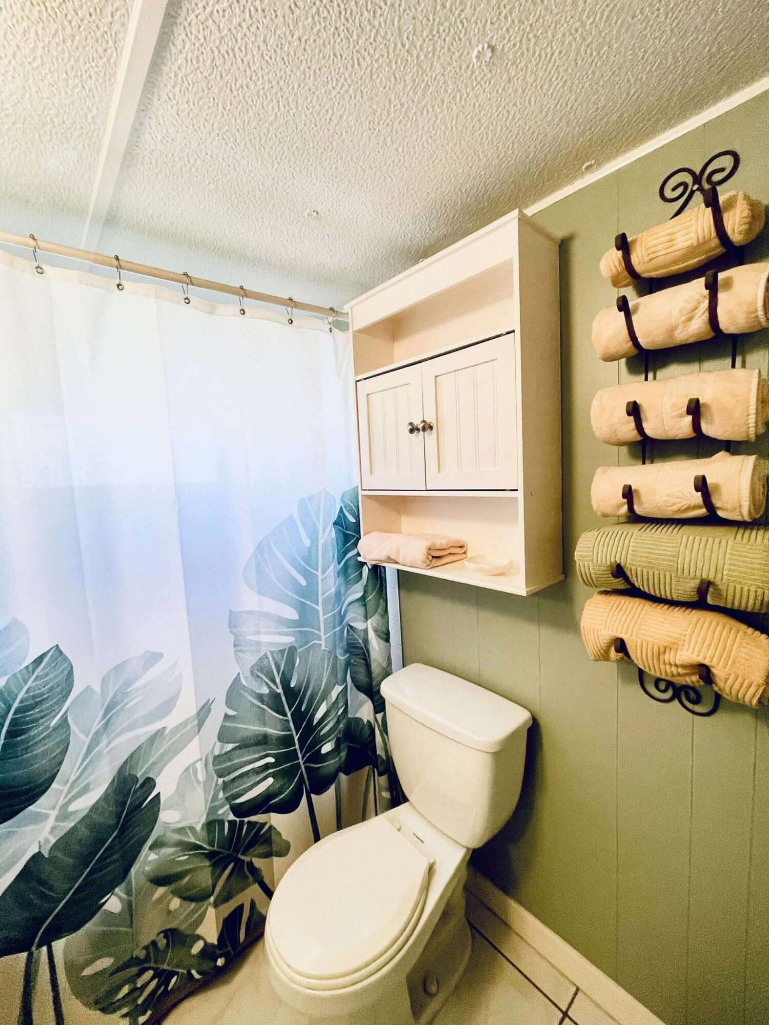 1601 Highway 441, Unit 61 Okeechobee, FL 34974 - Photo 18 of 35 a white toilet sitting next to a bathroom sink