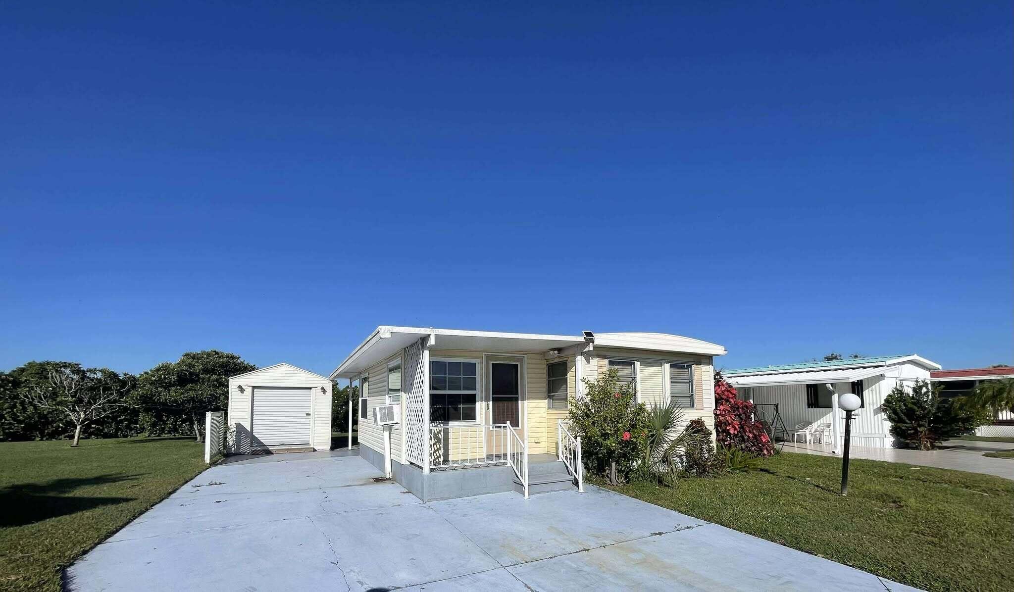 1601 Highway 441, Unit 61 Okeechobee, FL 34974 - Photo 35 of 35 a view of a house with backyard porch and garden