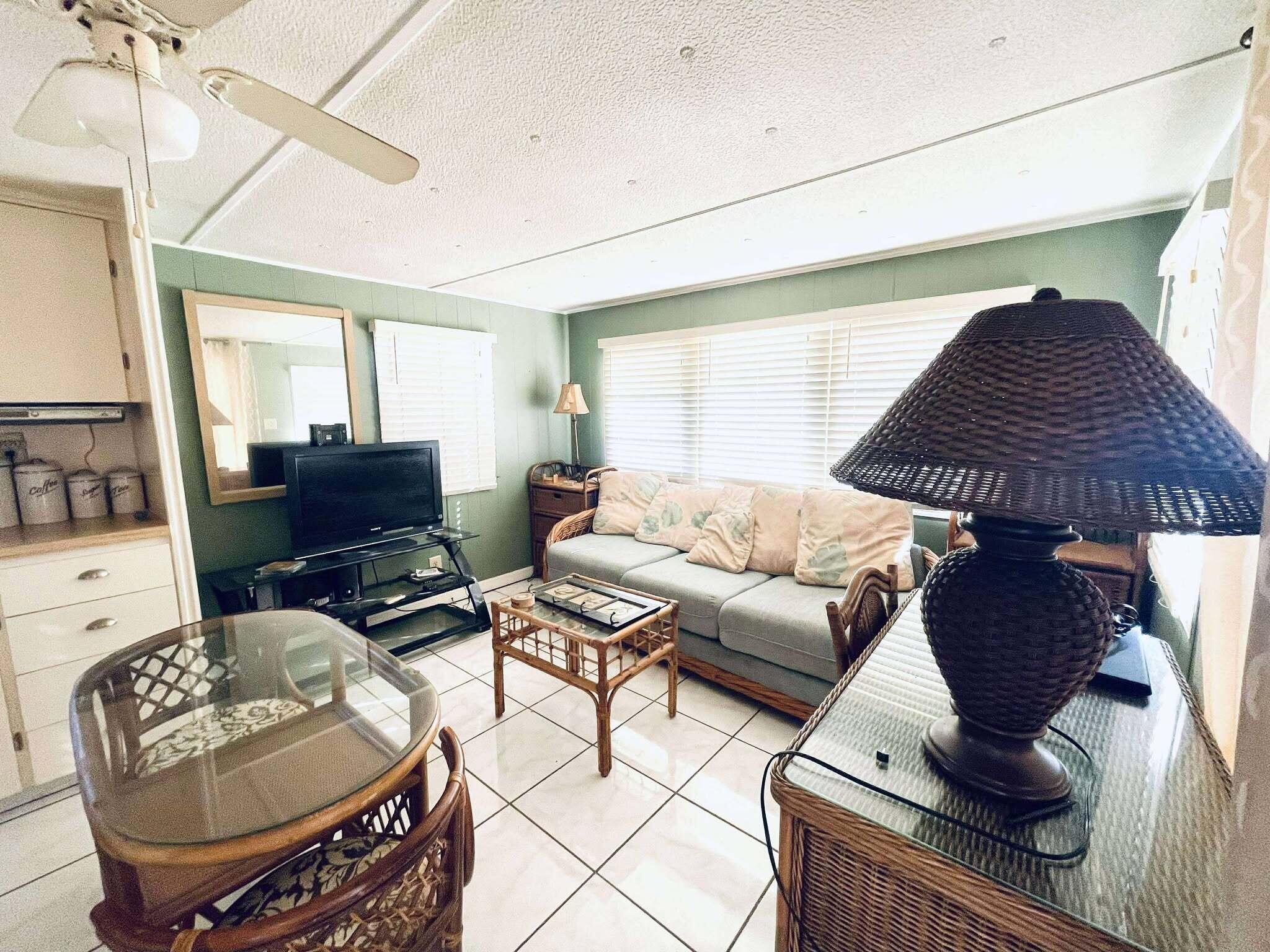 1601 Highway 441, Unit 61 Okeechobee, FL 34974 - Photo 7 of 35 a living room with furniture and wooden floor