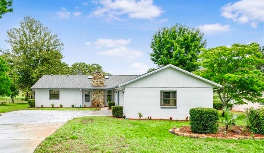 a view of a house with a yard and plants