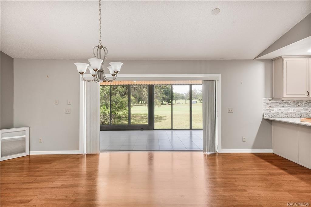 8831 East Sandpiper Drive Inverness, FL 34450 - Photo 11 of 44 a view of an empty room with wooden floor and a window