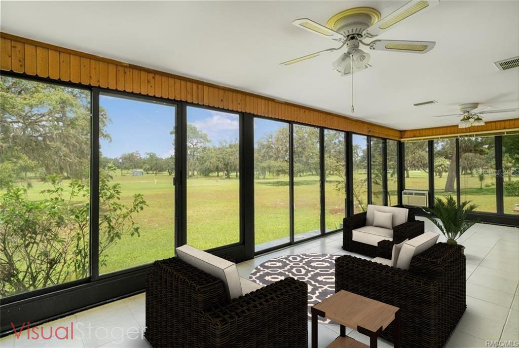 8831 East Sandpiper Drive Inverness, FL 34450 - Photo 12 of 44 a living room with furniture and a floor to ceiling window