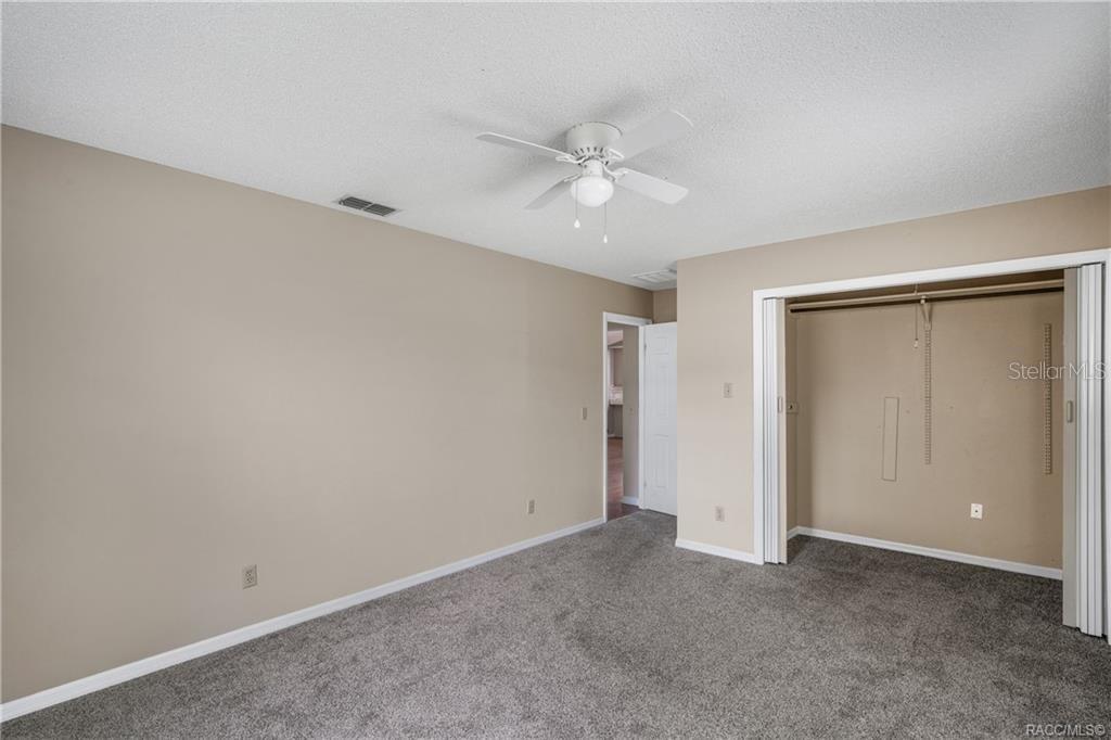 8831 East Sandpiper Drive Inverness, FL 34450 - Photo 20 of 44 an empty room with closet and a ceiling fan