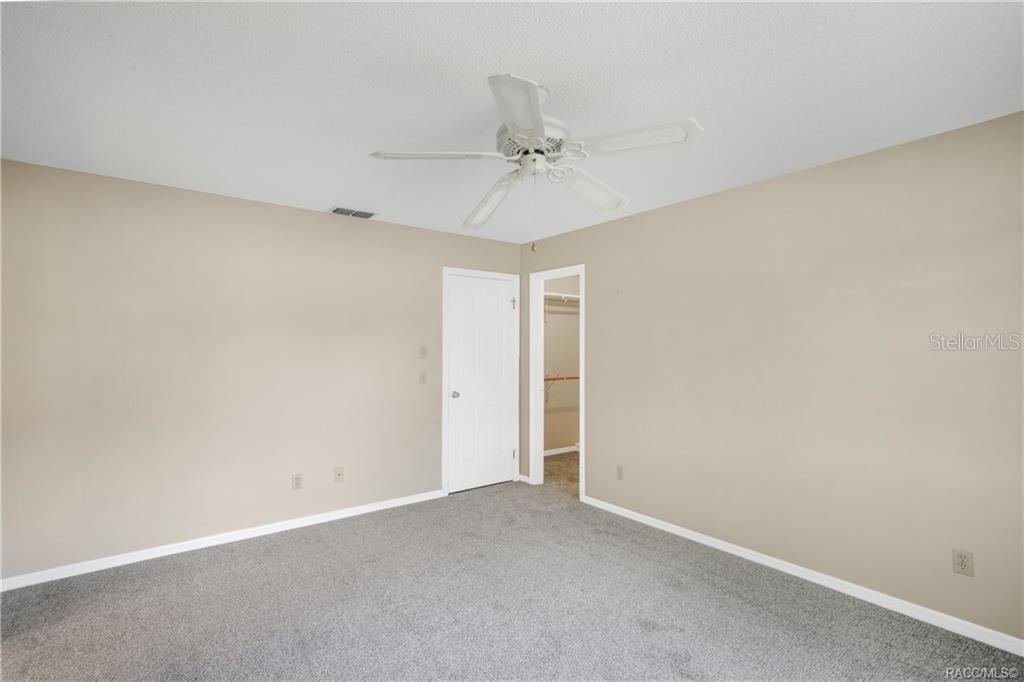 8831 East Sandpiper Drive Inverness, FL 34450 - Photo 21 of 44 an empty room with a ceiling fan and a window