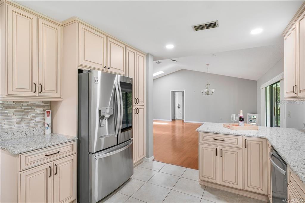 8831 East Sandpiper Drive Inverness, FL 34450 - Photo 10 of 44 a kitchen with stainless steel appliances a refrigerator sink and cabinets