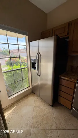 a room with a window and a refrigerator