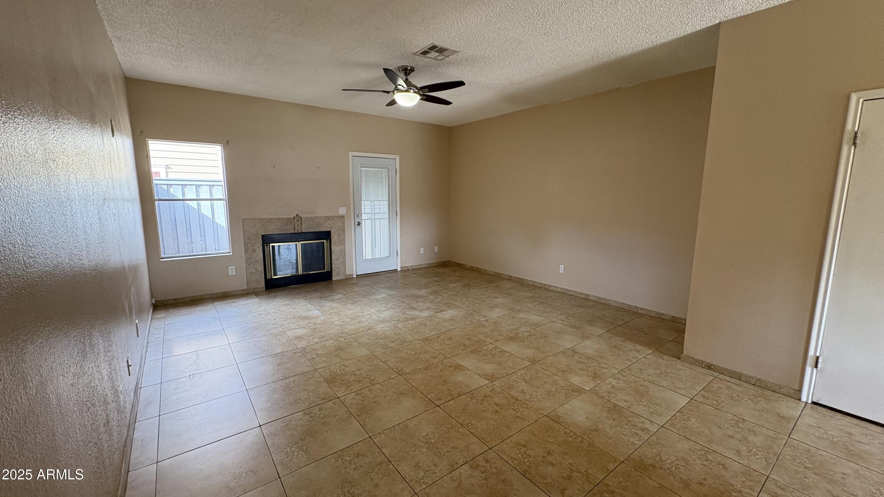 18626 North 33rd Drive, Unit 1 Phoenix, AZ 85027 - Photo 14 of 38 a view of an empty room with a fireplace