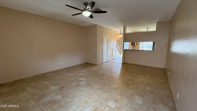 a view of a livingroom with a ceiling fan and window