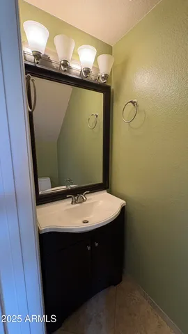 a bathroom with a sink a mirror and vanity