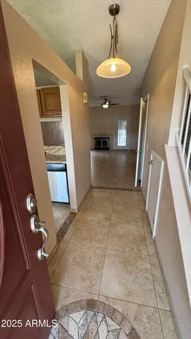 a view of entryway and kitchen