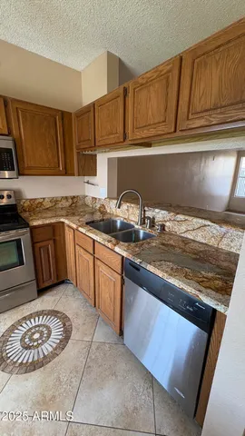 a kitchen with stainless steel appliances granite countertop a sink stove and cabinets