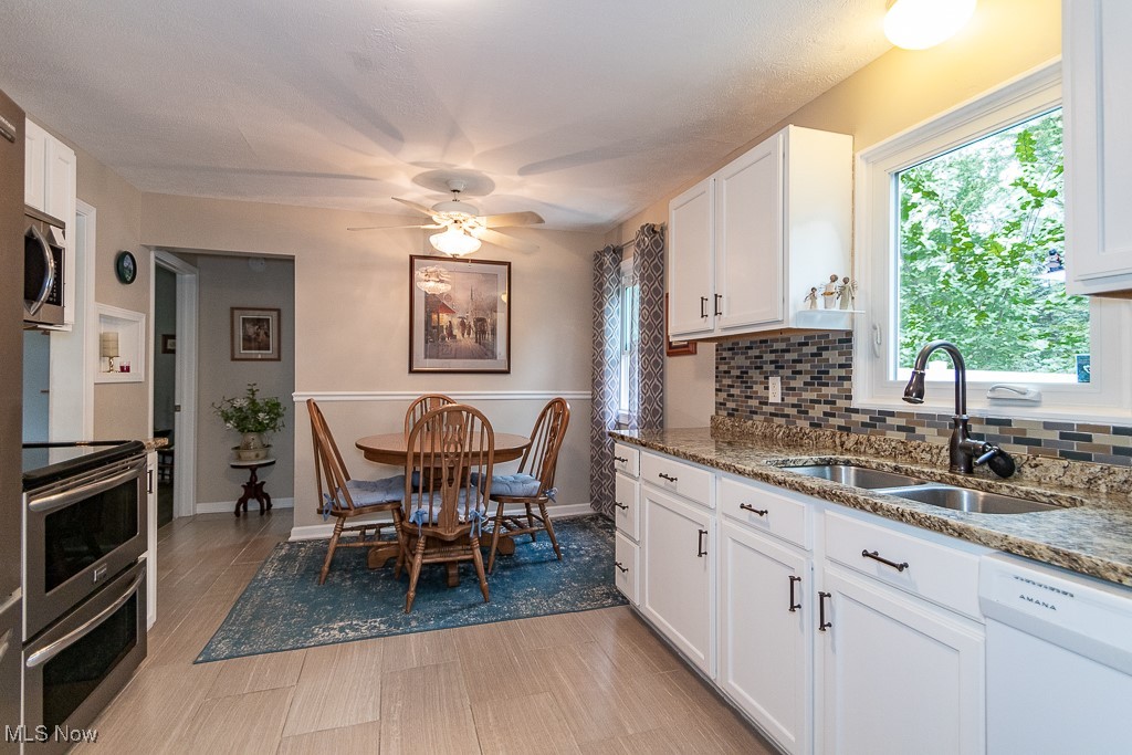 9479 Hoose Road Mentor, OH 44060 - Photo 9 of 20 Kitchen with appliances with stainless steel finishes, ceiling fan, sink, and white cabinets