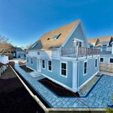 a view of a house with a wooden deck