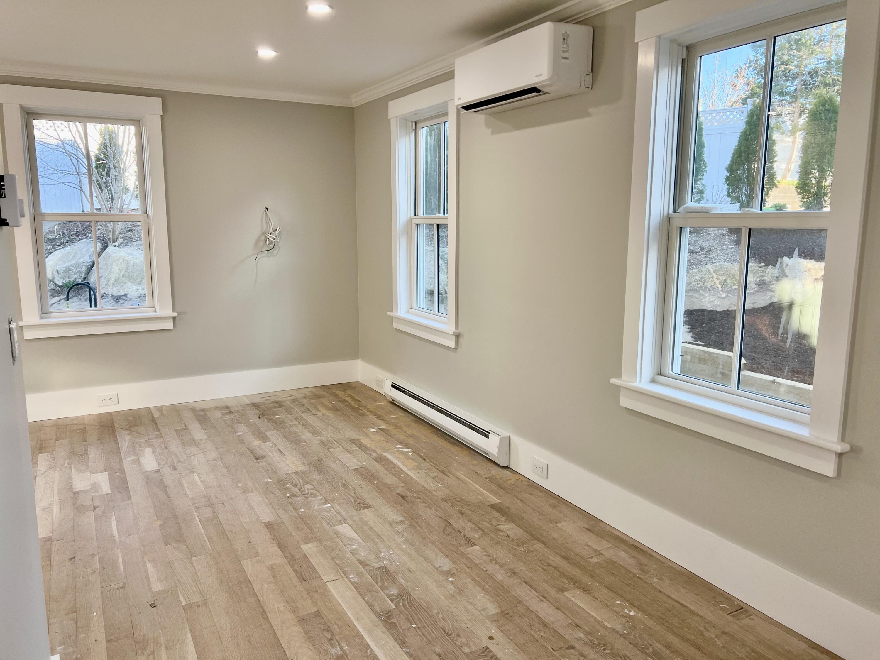 6 Race Road Provincetown, MA 02657 - Photo 22 of 30 an empty room with wooden floor and windows