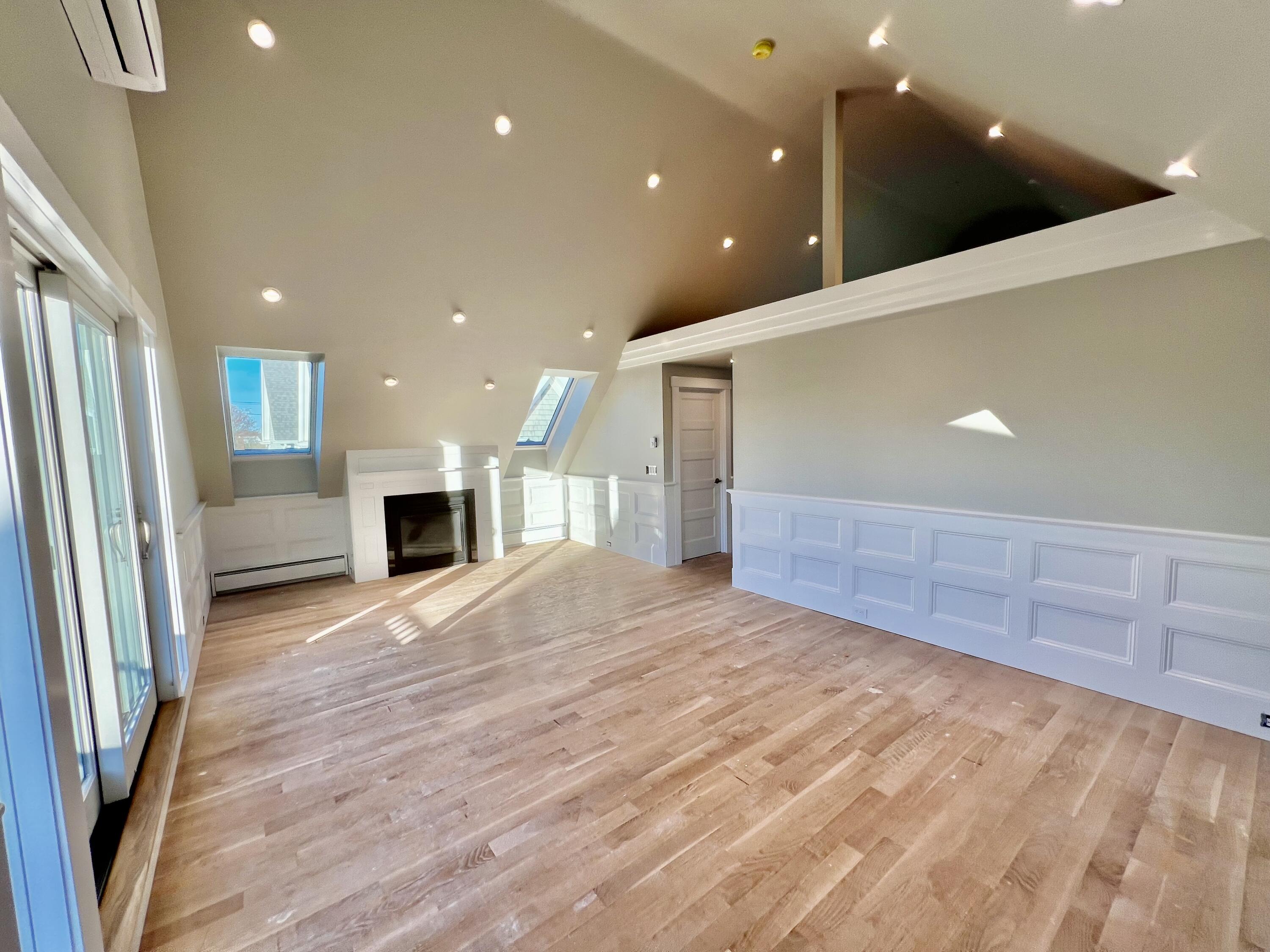 6 Race Road Provincetown, MA 02657 - Photo 5 of 30 a view of an empty room with wooden floor and a kitchen