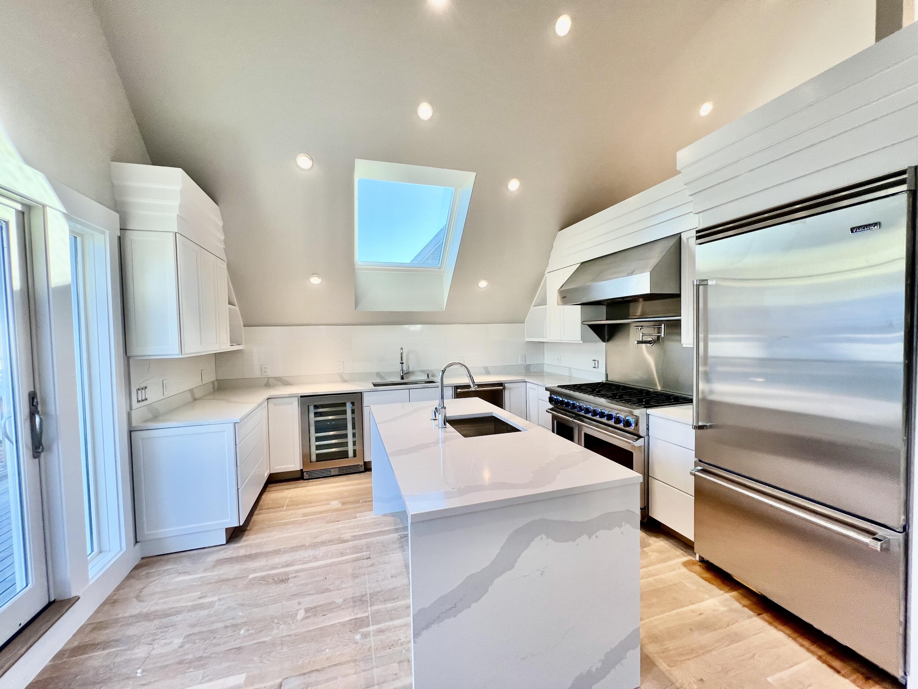 6 Race Road Provincetown, MA 02657 - Photo 7 of 30 a kitchen with a refrigerator sink and stove