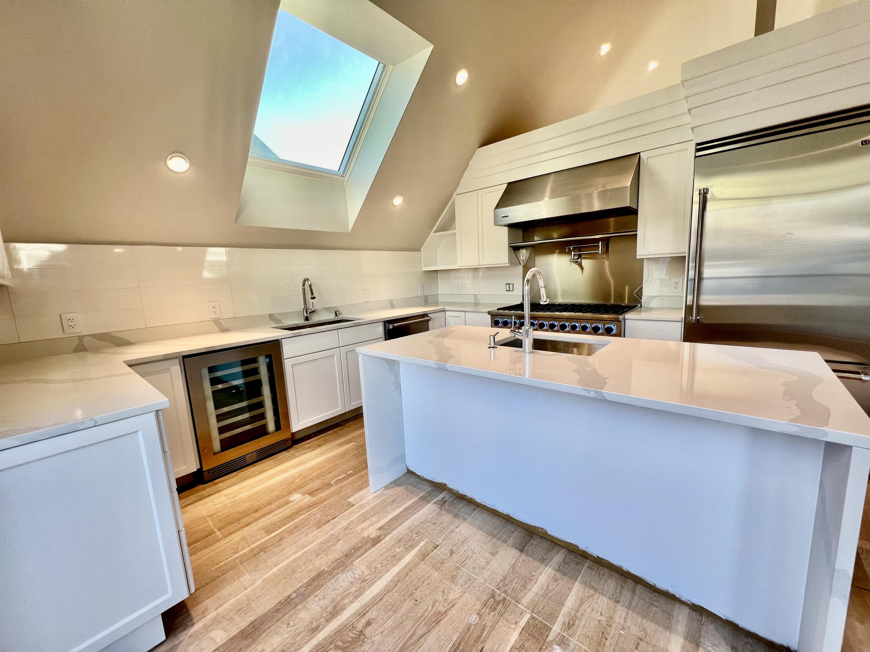 6 Race Road Provincetown, MA 02657 - Photo 8 of 30 a kitchen with stainless steel appliances a stove a microwave a sink and a refrigerator
