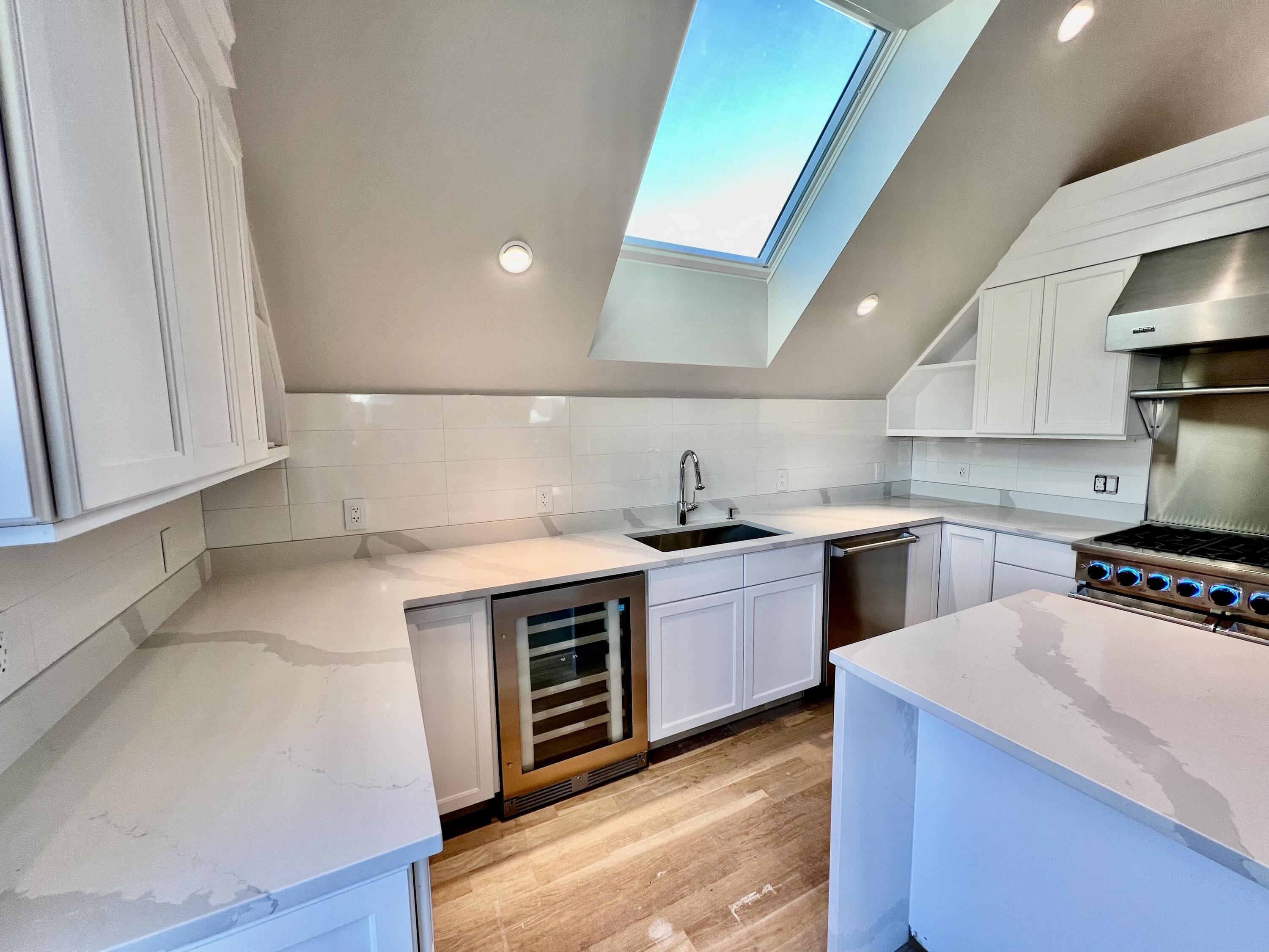 6 Race Road Provincetown, MA 02657 - Photo 9 of 30 a kitchen with stainless steel appliances a sink stove and wooden floor