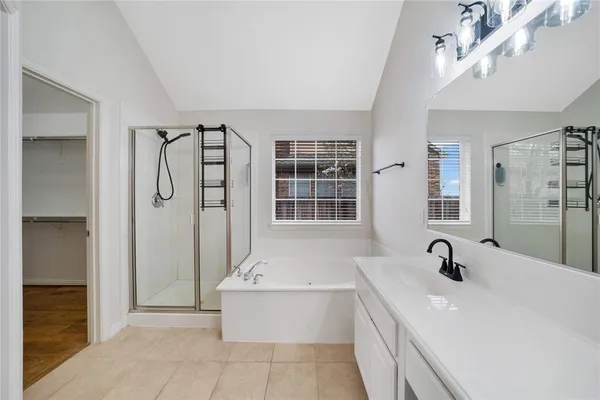 a bathroom with a tub sink and mirror