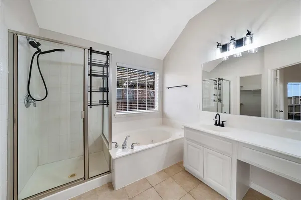 a bathroom with a granite countertop sink a mirror and shower