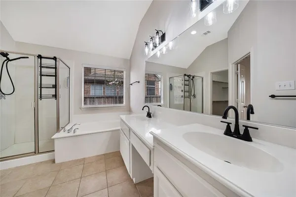 a spacious bathroom with a sink a large mirror and a bathtub