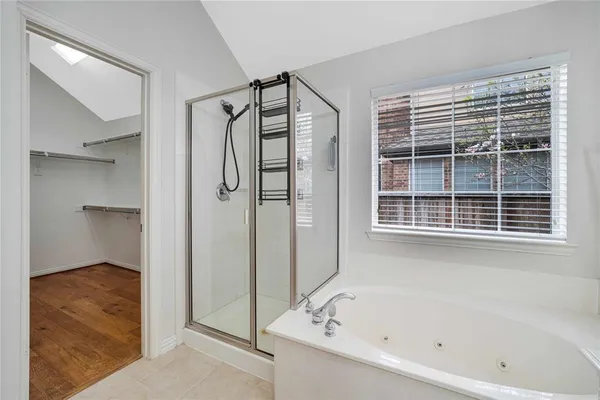 a bathroom with a bathtub and a shower