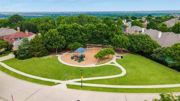 an aerial view of a house with swimming pool and a yard