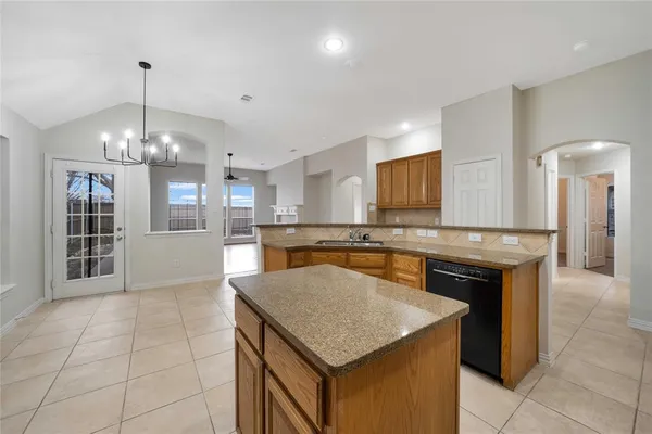 a kitchen with stainless steel appliances granite countertop a sink a counter top space cabinets and stainless steel appliances