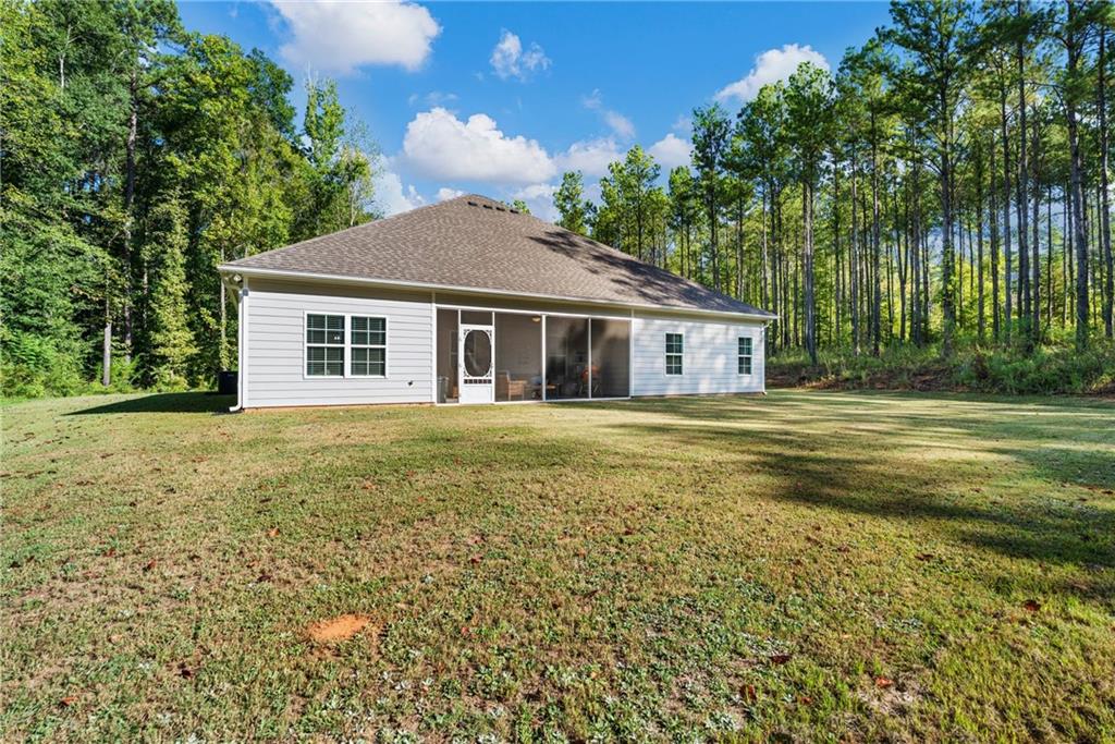3696 Lee Road Salem, AL 36874 - Photo 30 of 36 White siding exterior with a screened porch, multiple windows, and a shingle roof