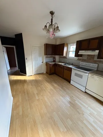 a kitchen with kitchen island granite countertop a sink stainless steel appliances and cabinets
