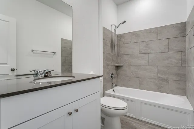 a bathroom with a sink a toilet and bathtub