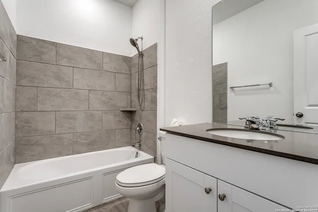 a bathroom with a sink a toilet and bathtub