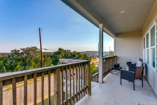 a view of a balcony with furniture