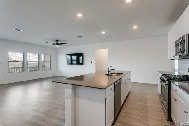 a kitchen with granite countertop a stove and a sink