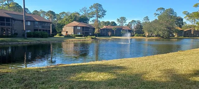 a view of a lake with a house in the background