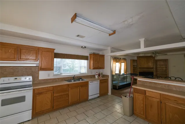 a kitchen with stainless steel appliances a stove sink and microwave