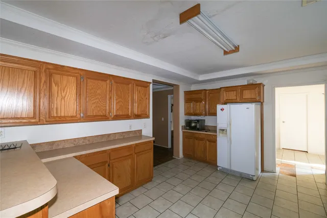 a kitchen with refrigerator cabinets and stainless steel appliances