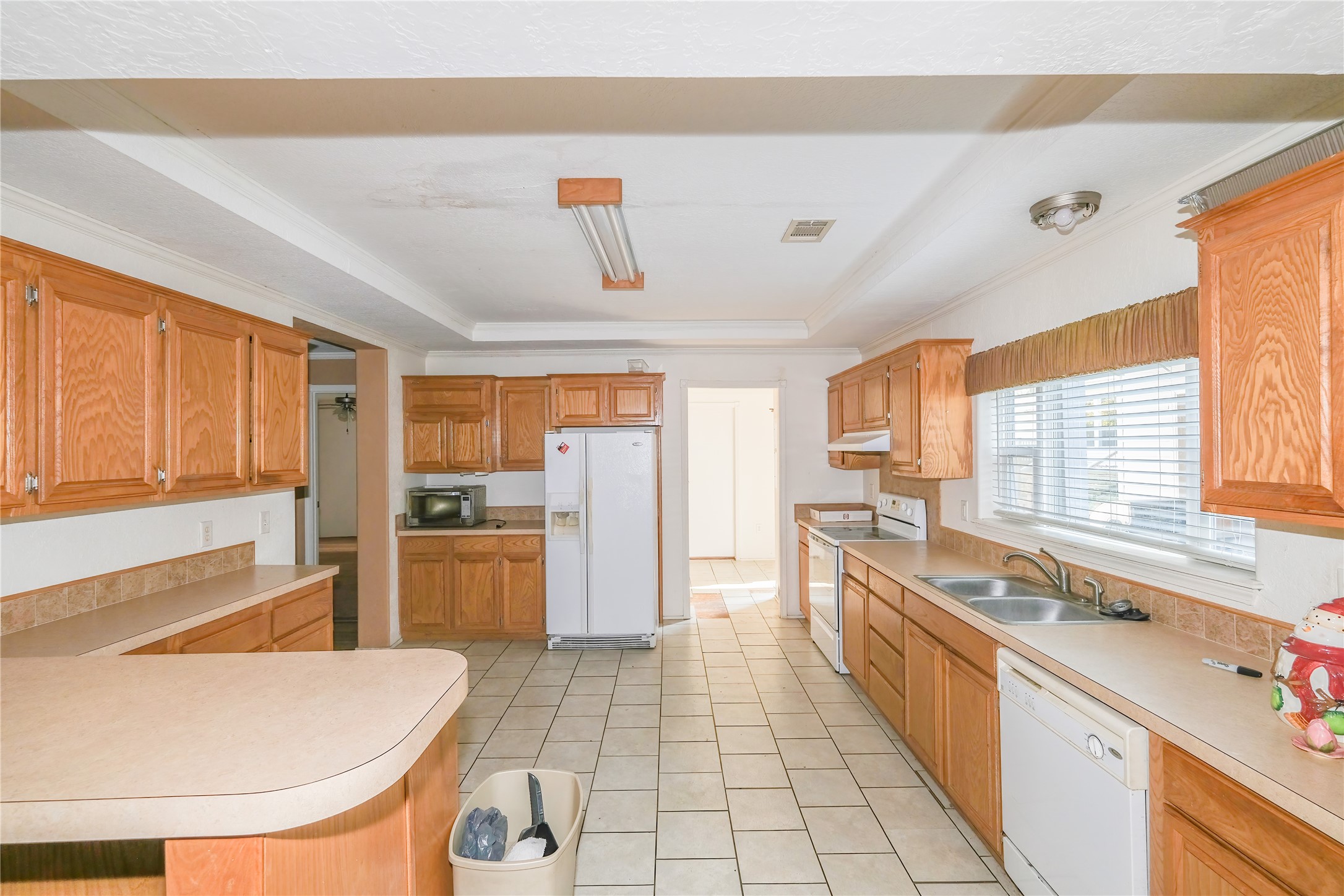 174 W Creek Trinity, TX 75862 - Photo 7 of 49 a large kitchen with a large window and stainless steel appliances