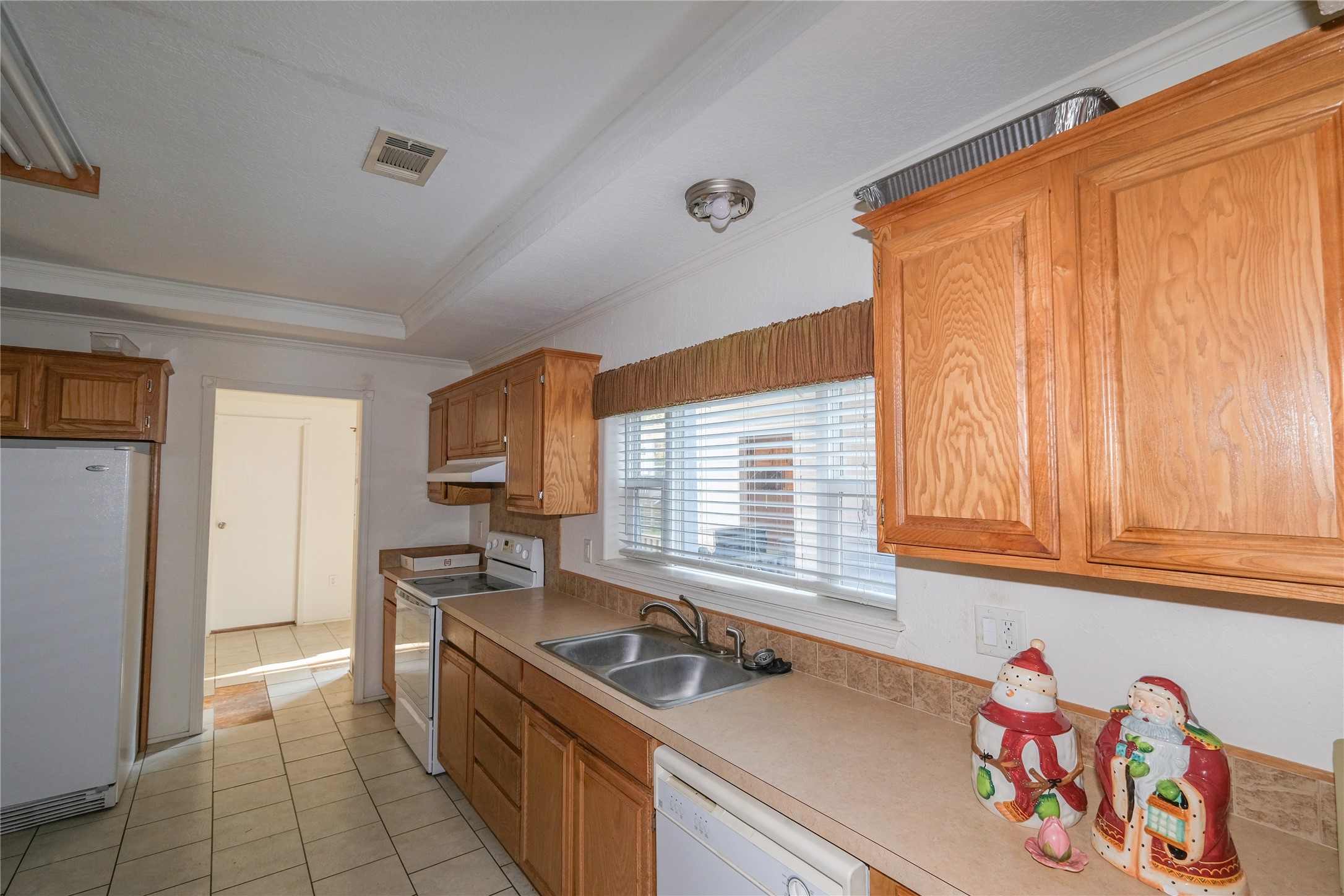 174 W Creek Trinity, TX 75862 - Photo 8 of 49 a kitchen that has a sink cabinets counter space and a window