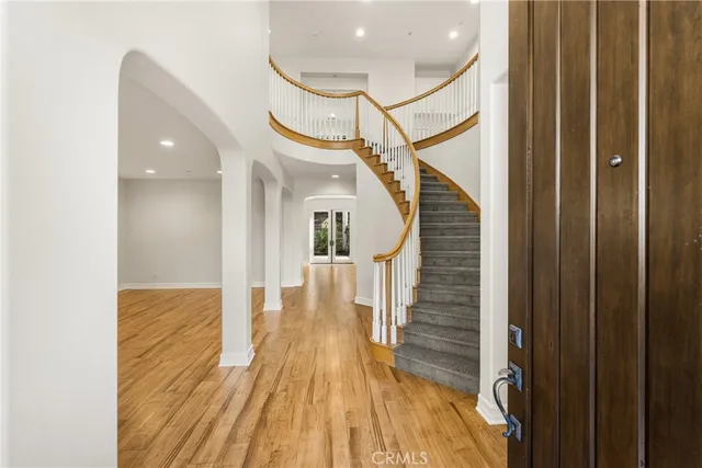 a view of entryway and hall with wooden floor