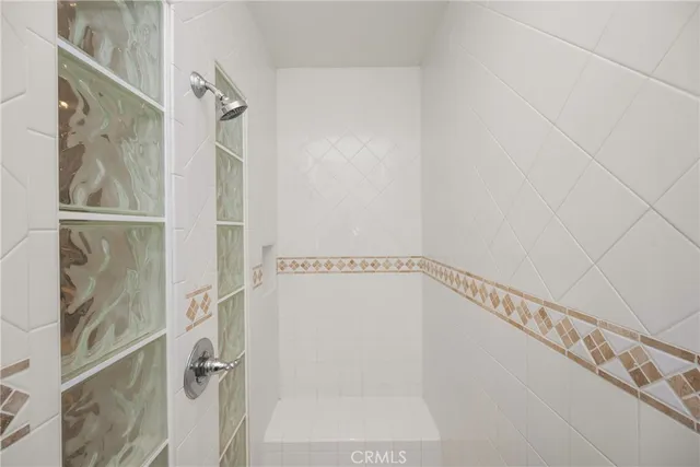 a bathroom with a glass shower door