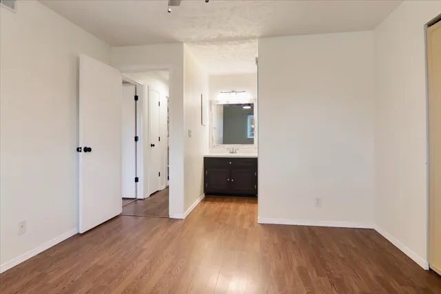 a view of a room with wooden floor and white walls