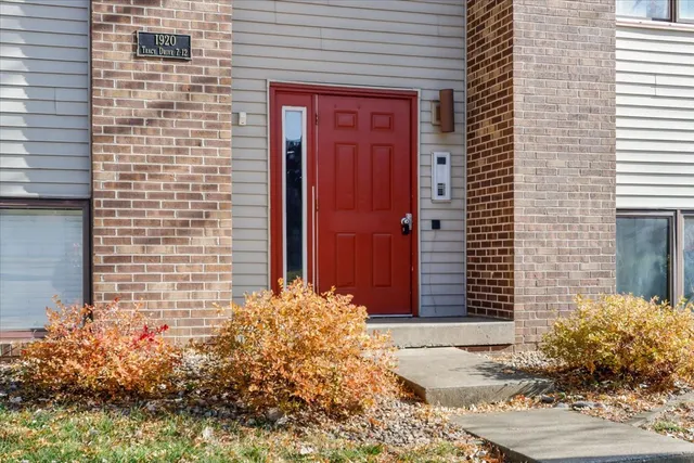 a view of a brick house with potted plants