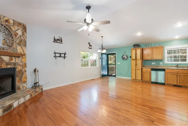 a kitchen with stainless steel appliances granite countertop a refrigerator a sink and a stove