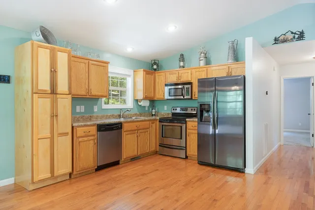 a kitchen with stainless steel appliances a refrigerator and a stove top oven