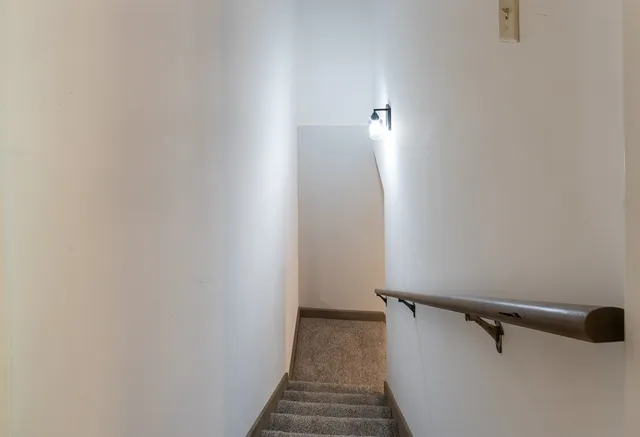 a view of a livingroom with a ceiling fan and window