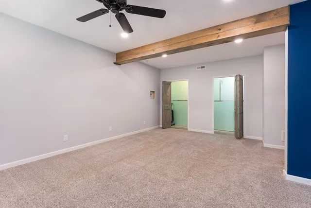a view of an empty room with a fireplace
